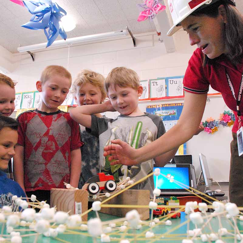 Children learning STEM from woman teacher