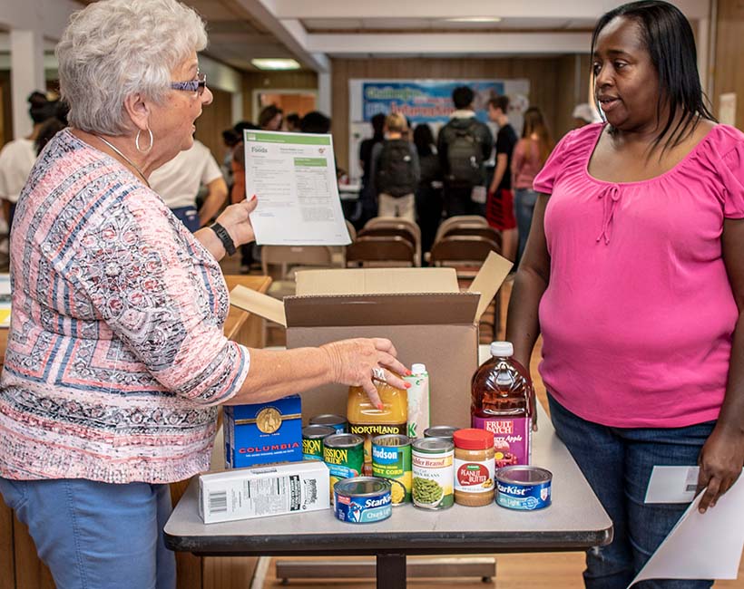 Volunteers organize food for distribution at a food pantry.