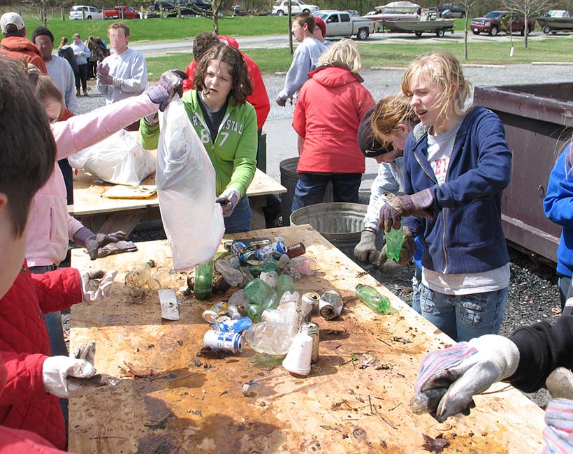 teenagers sift through trash during a volunteerism event