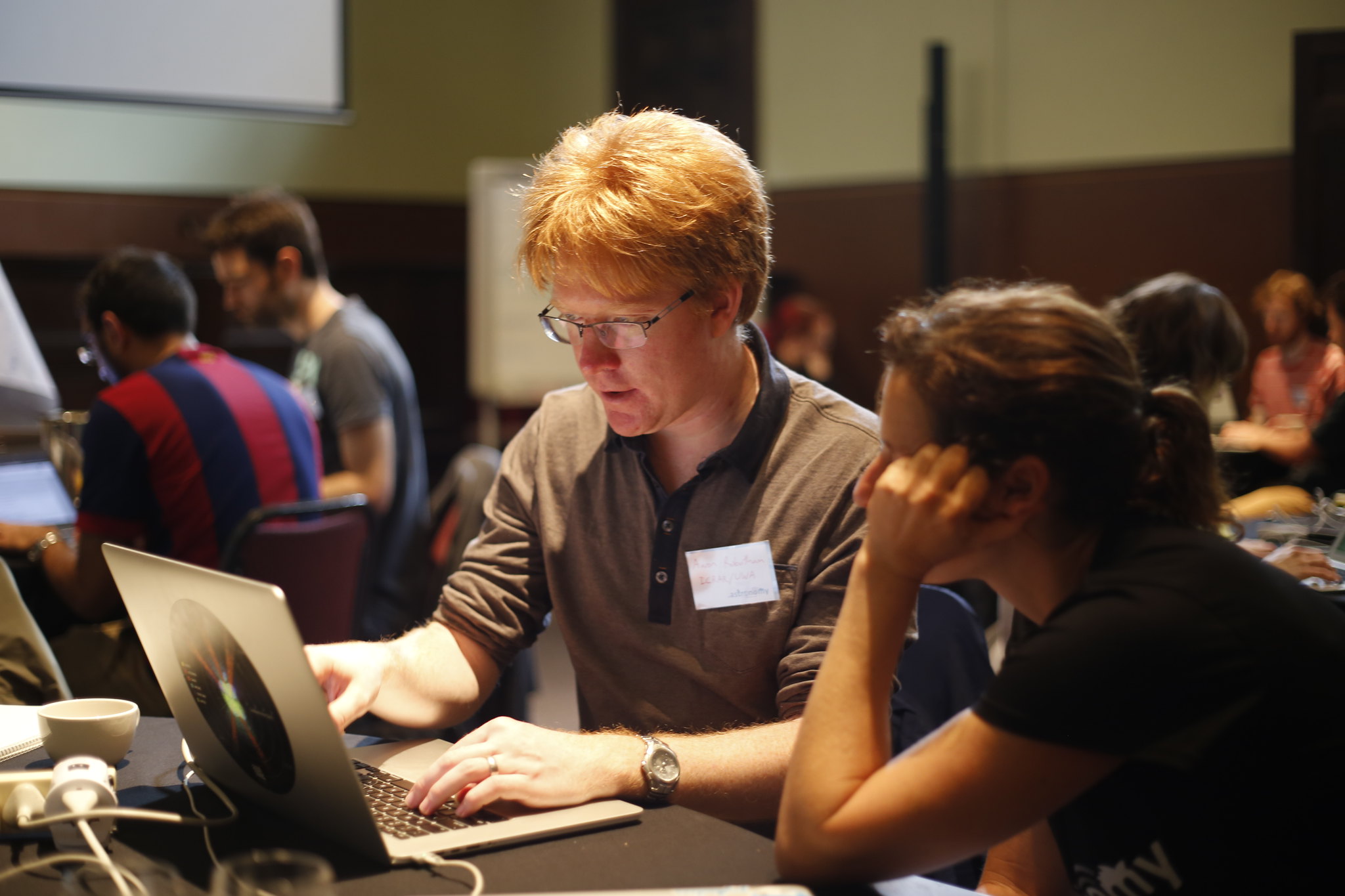 People strategizing at a laptop